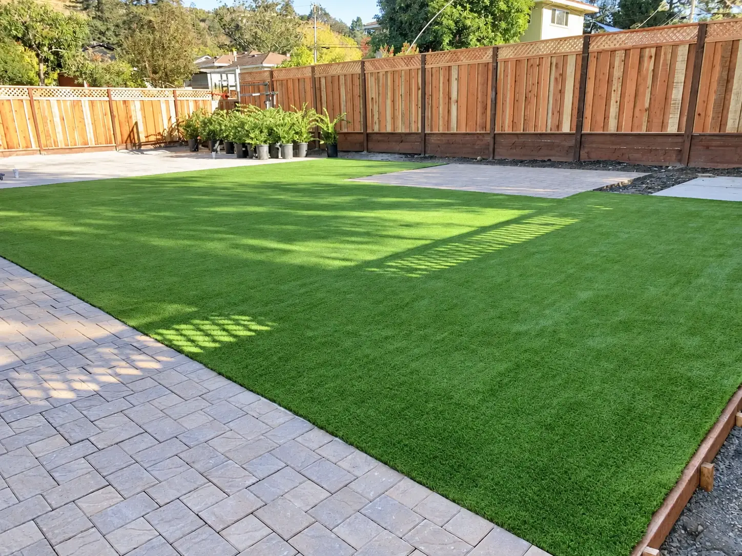 Artificial turf, pavers and wood fencing installed by Garescape in San Jose, California