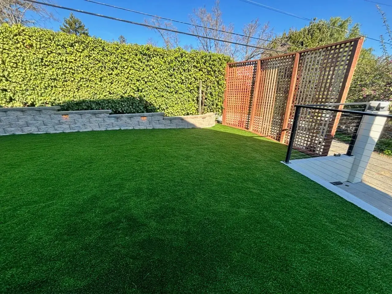 Artificial turf lawn with retaining wall installed by Garescape in Sunnyvale, California