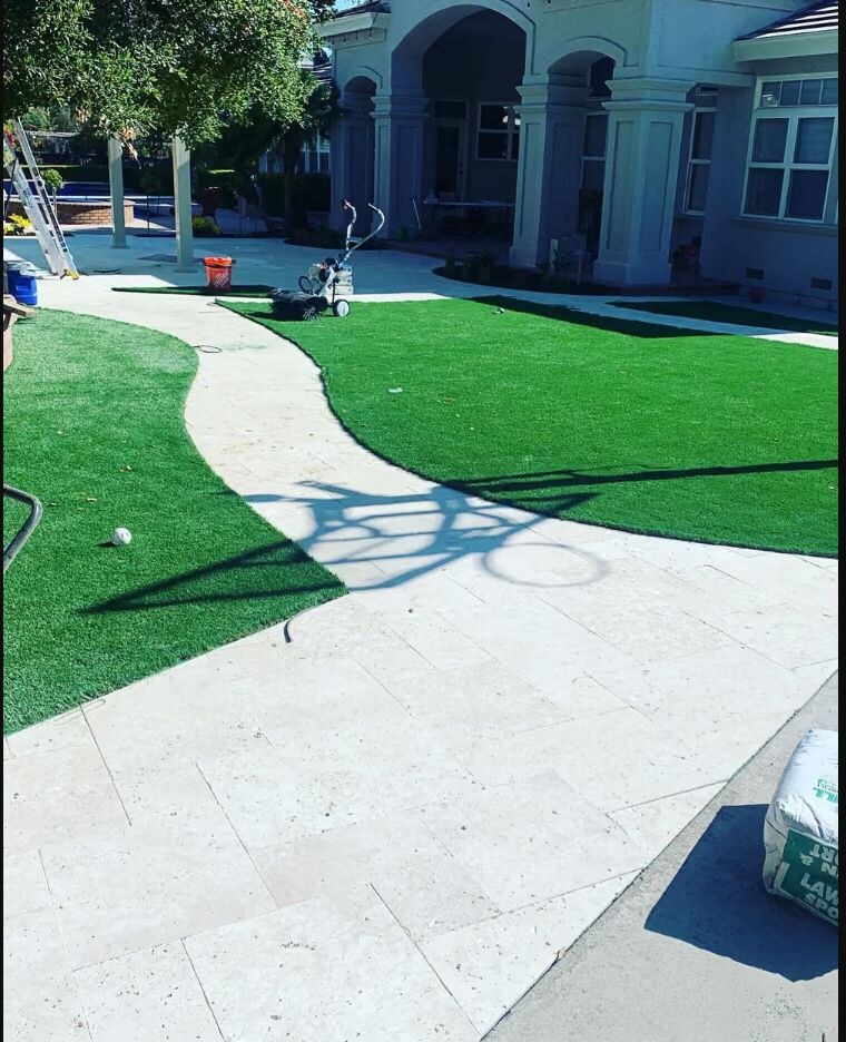 Artificial turf installation with a custom stone walkway