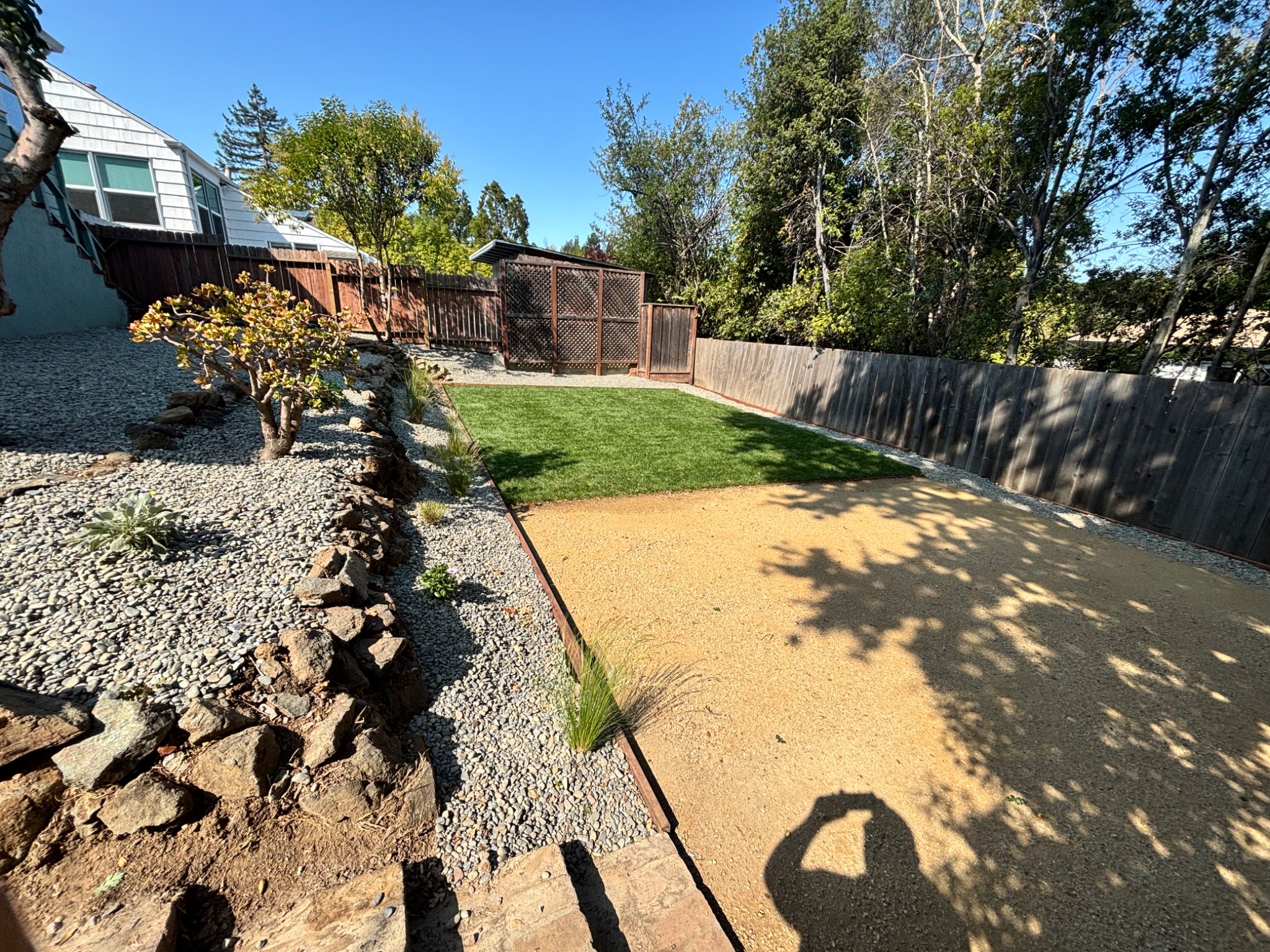Completed backyard landscaping with lawn, gravel and planting in Santa Clara, California