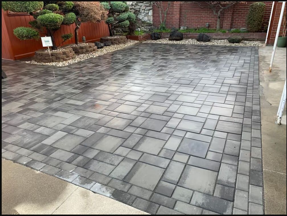 Gray paver patio with finished landscaping by Garescape