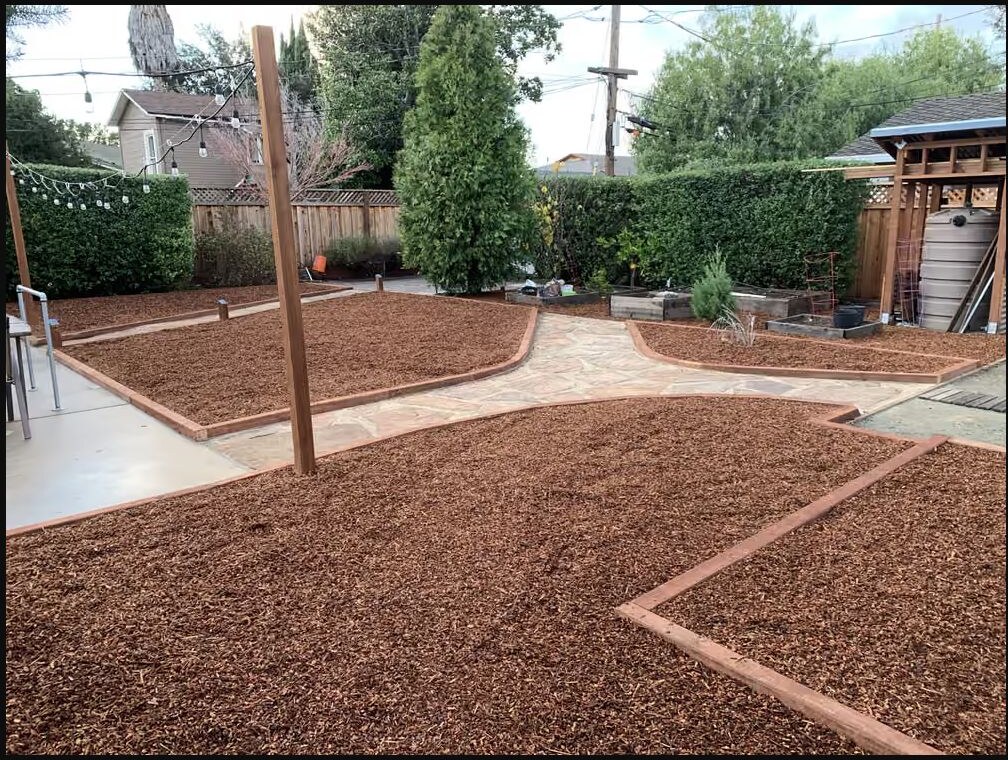 Landscape installation with stone pathway and mulch