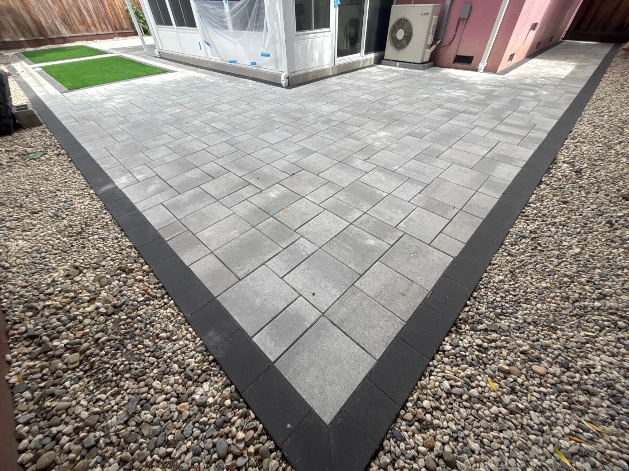 Modern gray paver patio with charcoal border installed by Garescape in the Bay Area