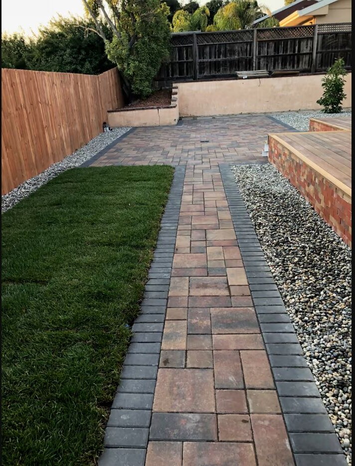 Paver walkway integrated with turf and decorative gravel